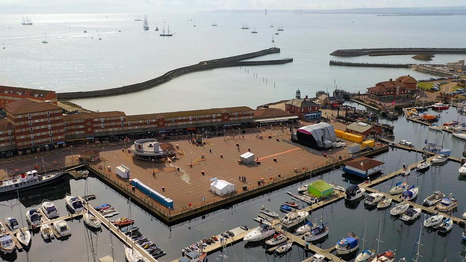 Aerial drone view of festival stage setup and crowd