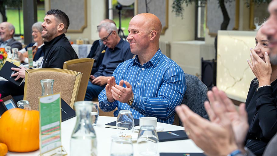 Audience member clapping during conference event