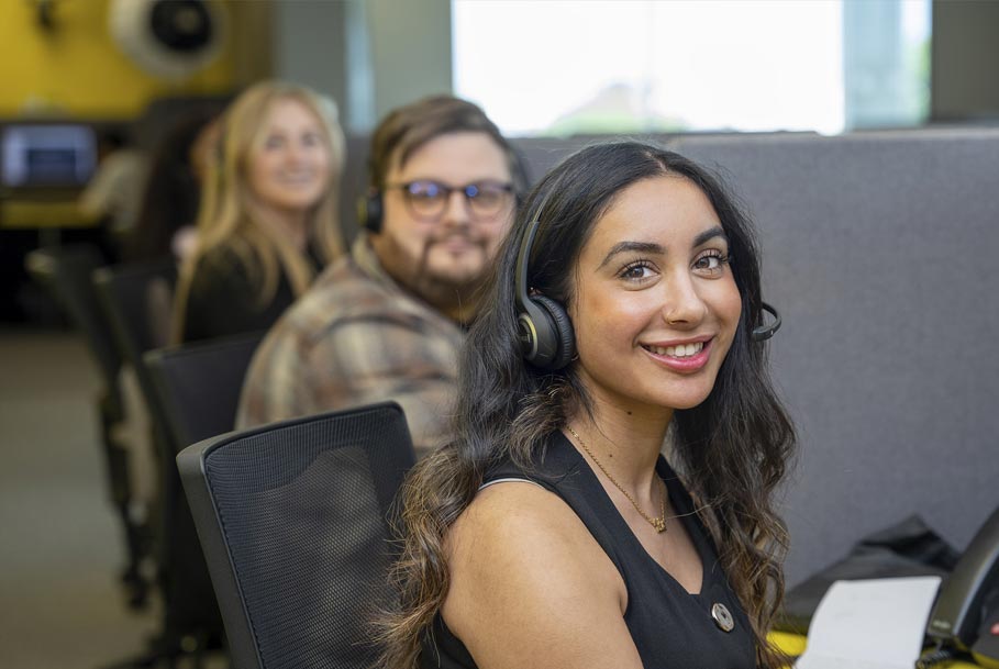 Call centre operator smiling directly at camera with headset – professional branding photography in Teesside