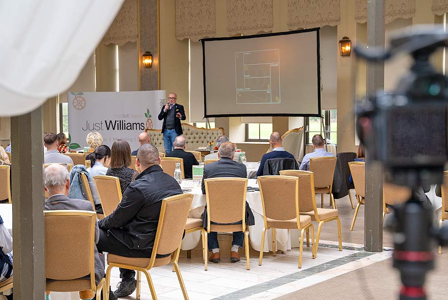 Corporate event stage with speaker and professional camera lights during video production in Stockton-on-Tees