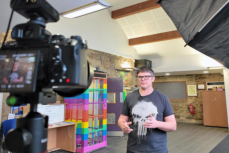 Professional corporate video interview filming with camera and lights in foreground – Teesside production