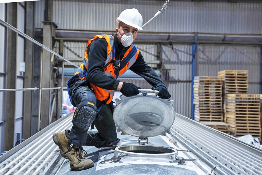 Branding photography of staff opening bulk wagon filling point during powder loading in Teesside