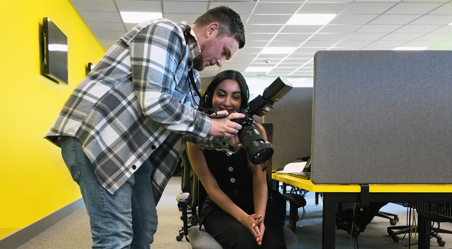 Photographer Jamie Kenley showing a preview on camera to a happy client during a business photoshoot in Teesside.