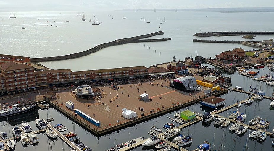 Aerial drone shot of festival concert stage with ocean sea backdrop – Teesside event videography and photography