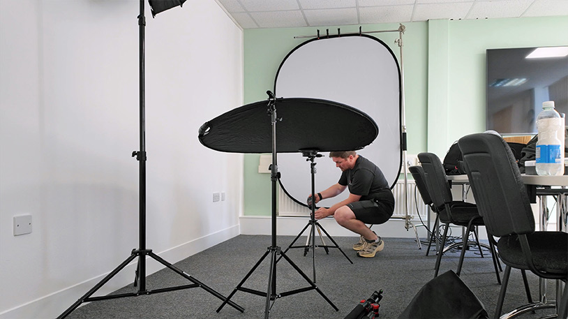 Behind the Scenes corporate photography headshot studio settup by tees vision media at Darlington Healthcare Jamie from Tees Vision Media setting up headshot studio onsite for Darlington Primary Healthcare on a healthcare phogoraphy shoot